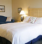 Osprey Shores deluxe room with a club chair and single sofa bed.